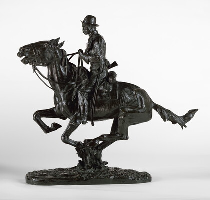 A bronze sculpture of a cowboy riding a galloping horse and holding a pistol close to his chest.