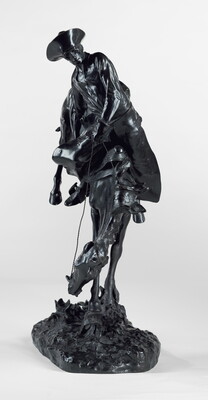 A bronze sculpture of a cowboy hanging onto a bucking bronco.