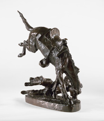 A bronze sculpture of a man on the ground hanging on to the head of his bucking horse.
