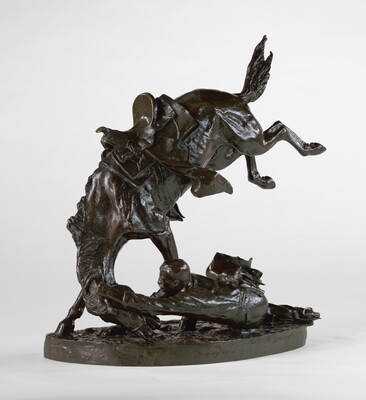 A bronze sculpture of a man on the ground hanging on to the head of his bucking horse.