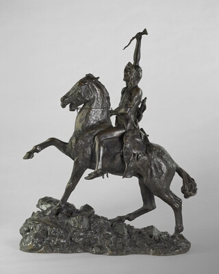 A bronze sculpture of a man on horseback holding a piece of scalp and hair in his hand thrusted above his head triumphantly.