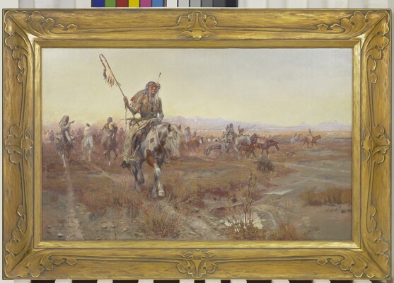 A Native American man wearing elaborate clothing leads a group on horseback through the plains.