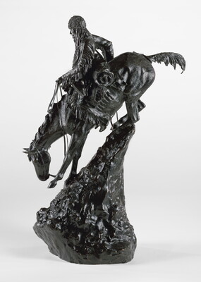 A bronze sculpture of a man going down a very steep mountain on horseback.