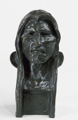 A bronze bust of an Indigenous man with long hair.