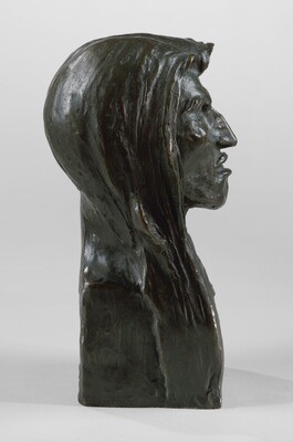A bronze bust of an Indigenous man with long hair.