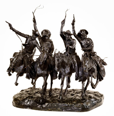 A bronze sculpture of four cowboys riding horses while holding their guns high in the air.