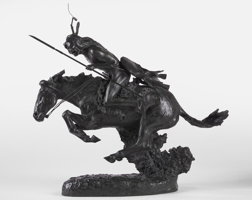 A bronze sculpture of an Indigenous person crouched on a running horse holding a spear and a whip.