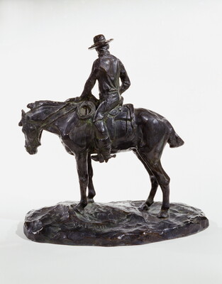 A bronze sculpture of a man wearing a cowboy hat seated on a standing horse.