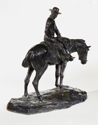 A bronze sculpture of a man wearing a cowboy hat seated on a standing horse.