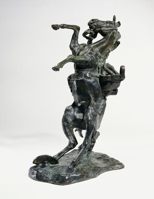 A bronze sculpture of a cowboy falling off the back of a rearing horse.