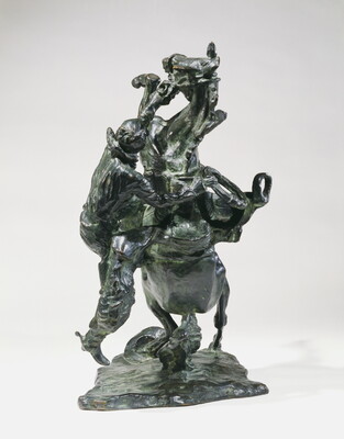 A bronze sculpture of a cowboy falling off the back of a rearing horse.