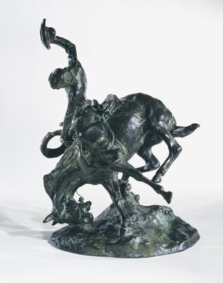 A bronze sculpture of a cowboy trying to ride a bucking horse.