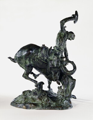 A bronze sculpture of a cowboy trying to ride a bucking horse.