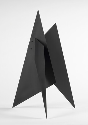 A black abstract tabletop sculpture with lots of triangular points.