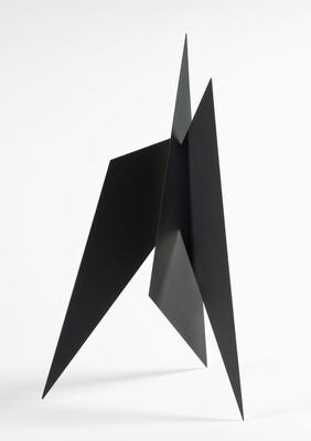 A black abstract tabletop sculpture with lots of triangular points.