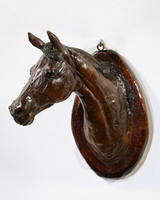 A wood mount of a horse's head and neck.