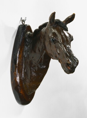A wood mount of a horse's head and neck.
