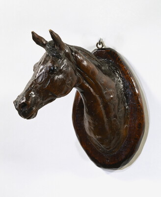 A wood mount of a horse's head and neck.