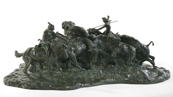 A bronze sculpture of two Native men, one with a spear and the other with a bow, on horseback circling a group of bison.