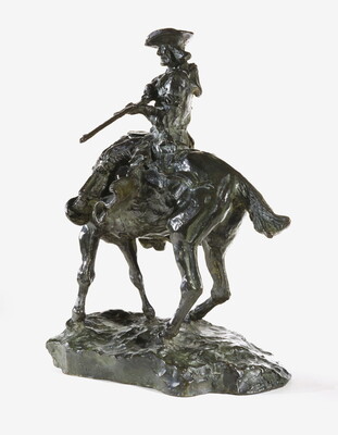 A bronze sculpture of a man on horseback pointing a long rifle.