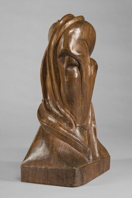A mahogany sculpture representing an abstracted head.
