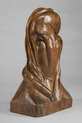 A mahogany sculpture representing an abstracted head.