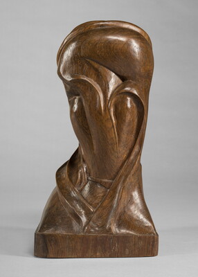 A mahogany sculpture representing an abstracted head.