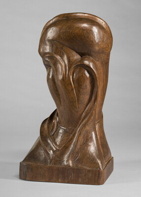 A mahogany sculpture representing an abstracted head.