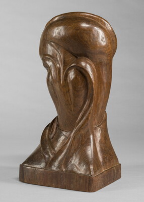 A mahogany sculpture representing an abstracted head.