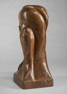 A mahogany sculpture representing an abstracted head.