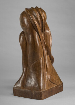 A mahogany sculpture representing an abstracted head.