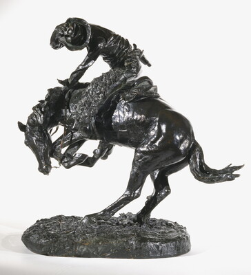 A sculpture of a man riding a bucking horse around a rattlesnake.