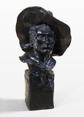 A bronze bust of a mustached man wearing a cowboy hat and a kerchief around his neck.