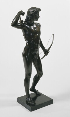 A bronze sculpture of a nude, male archer reaching for an arrow in the quiver on his back.