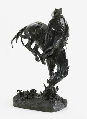 A bronze sculpture of a cowboy sitting on the back of a bucking bronco.