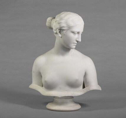 A marble bust of a bare-breasted woman.