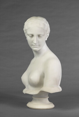 A marble bust of a bare-breasted woman.