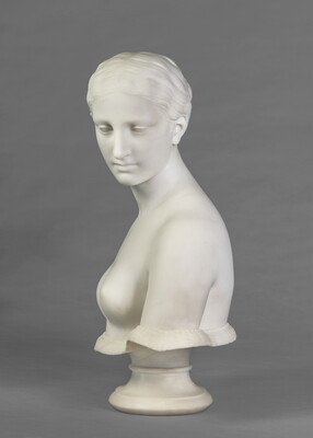 A marble bust of a bare-breasted woman.