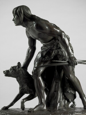 A bronze sculpture of a young man holding a bow and arrow, standing hunched low with a dog beside him.