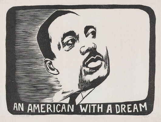 A black-and-white portrait print of the face of a Black man with a mustache above the words "An American with a Dream."