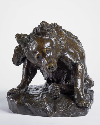 A bronze sculpture of a bear sitting on its haunches to clean itself with a hind leg.
