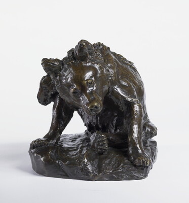 A bronze sculpture of a bear sitting on its haunches to clean itself with a hind leg.