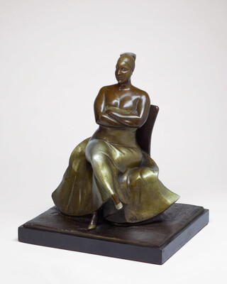 A bronze sculpture of a woman wearing an evening gown sitting with her legs and arms crossed.