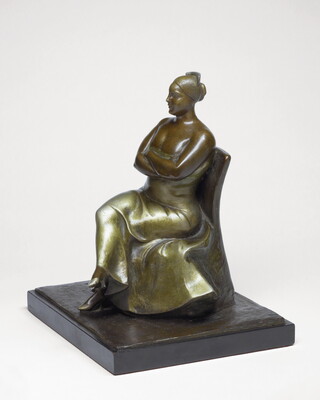 A bronze sculpture of a woman wearing an evening gown sitting with her legs and arms crossed.
