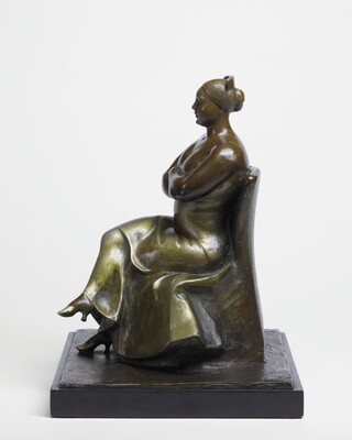 A bronze sculpture of a woman wearing an evening gown sitting with her legs and arms crossed.
