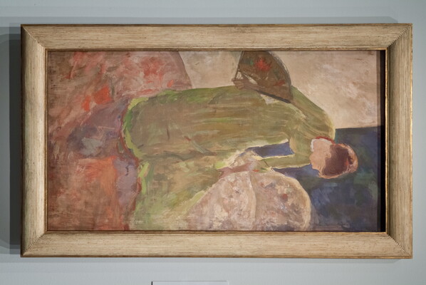 A painting of a woman in a green dress holding a fan and bending to arrange the train of her dress.