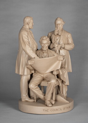 A sculpture of Abraham Lincoln, seated, reading a paper between two standing men.