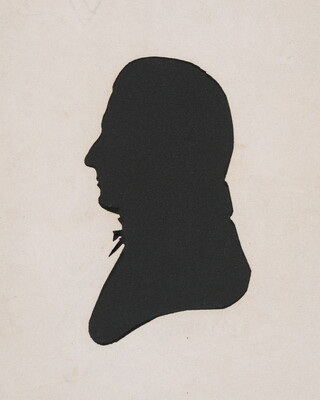 A silhouette of a man in profile; he has a prominent nose and a bow tie at his neck.