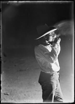 cowboy lighting cigarette Lot Cowboy lighting a hand-rolled cigarette