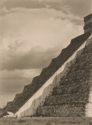 A black-and-white photograph of the diagonal corner edge of a Mayan step-pyramid.